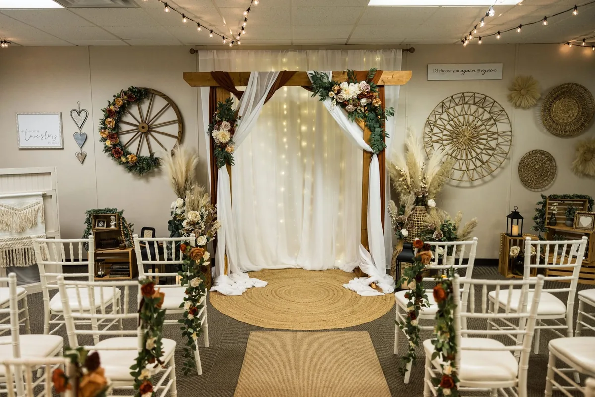The intimate ceremony room at The Loft Reno, with its draped arch and white chairs