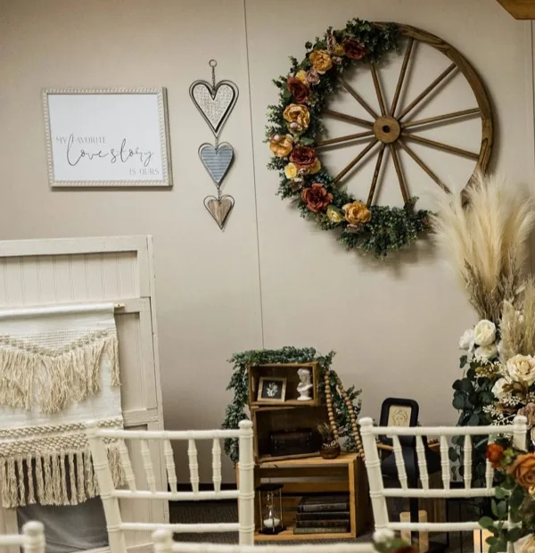 A floral wagon-wheel wreath, macramé and framed details inside The Loft.